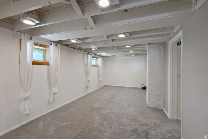 Spacious family room featuring freshly cleaned carpet, fresh paint , recessed lighting, and new  windows