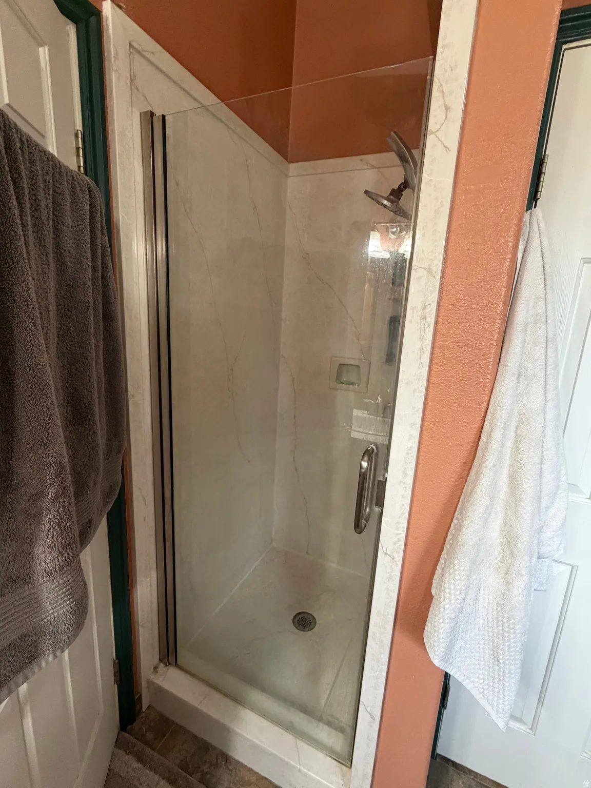Walk-in shower  In master bathroom with European style clear glass enclosure and a polished chrome showerhead