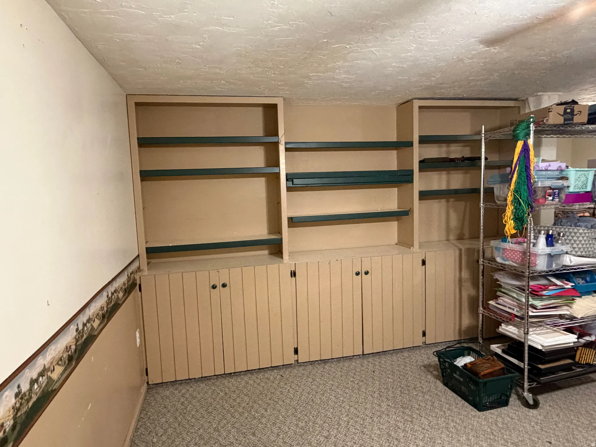 Built-in shelving units featuring open shelves and lower cabinet storage