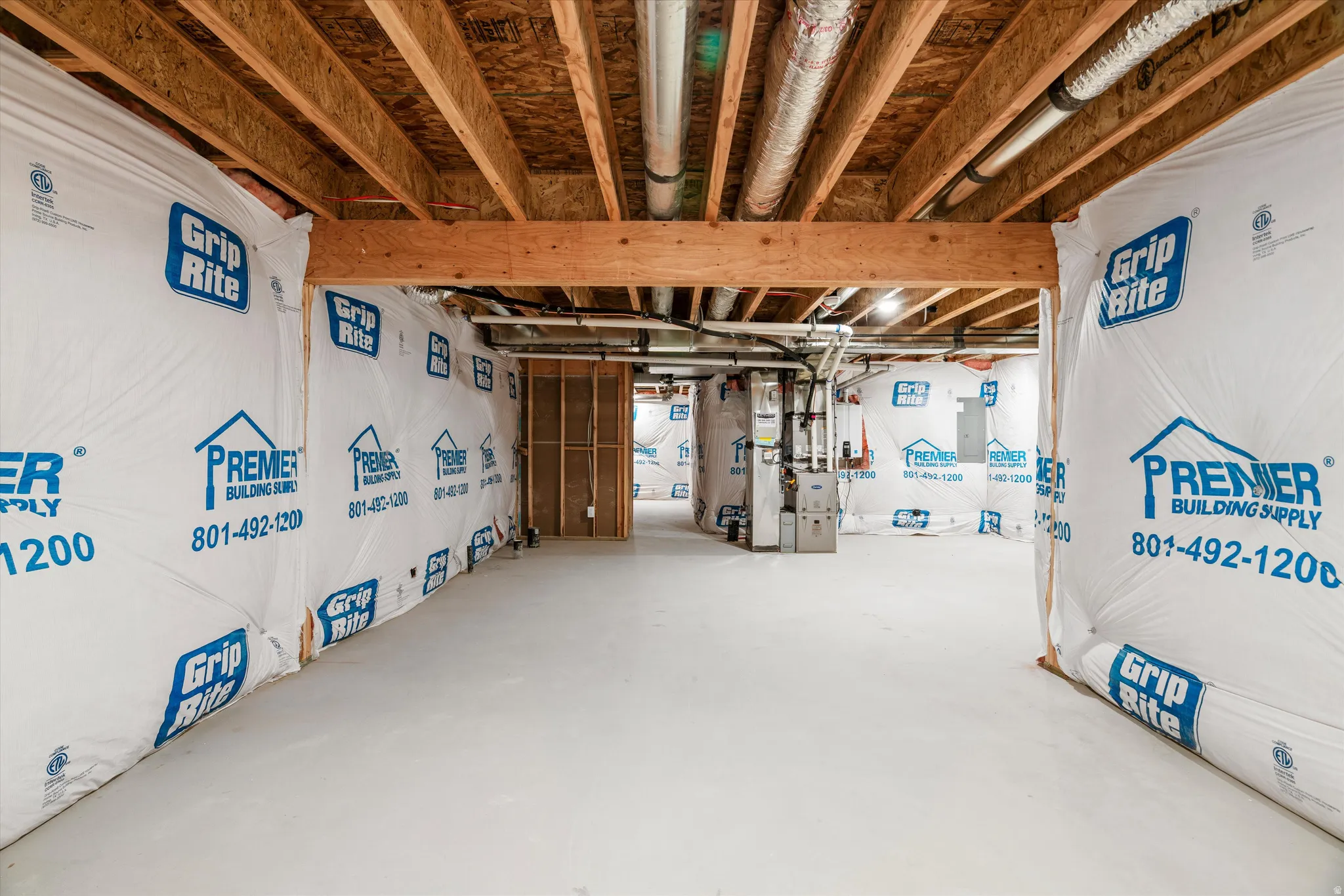 Unfinished basement offering substantial square footage, exposed wooden joists, and a concrete floor