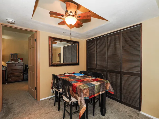 Tray ceiling featuring a ceiling fan with integrated lighting