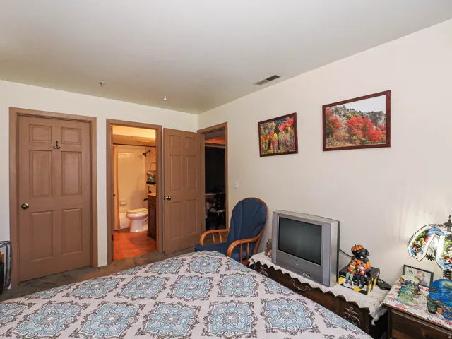 Carpeted room with light-colored walls and brown trim