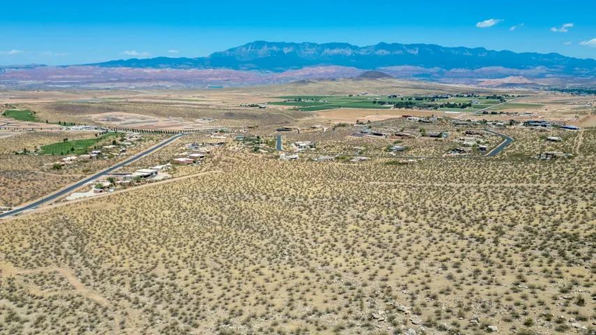 Expansive desert landscape featuring scattered low-lying vegetation