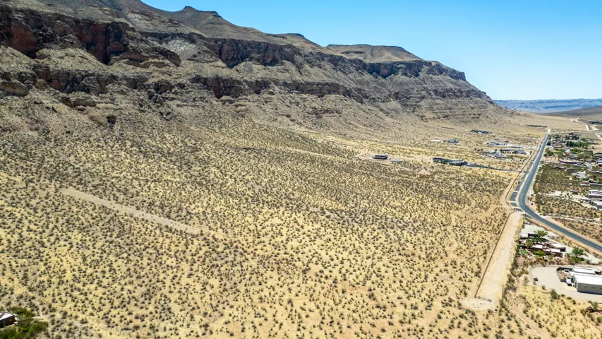 Expansive desert landscape featuring rugged mountain formations
