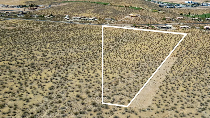 Expansive desert lot featuring a defined property boundary