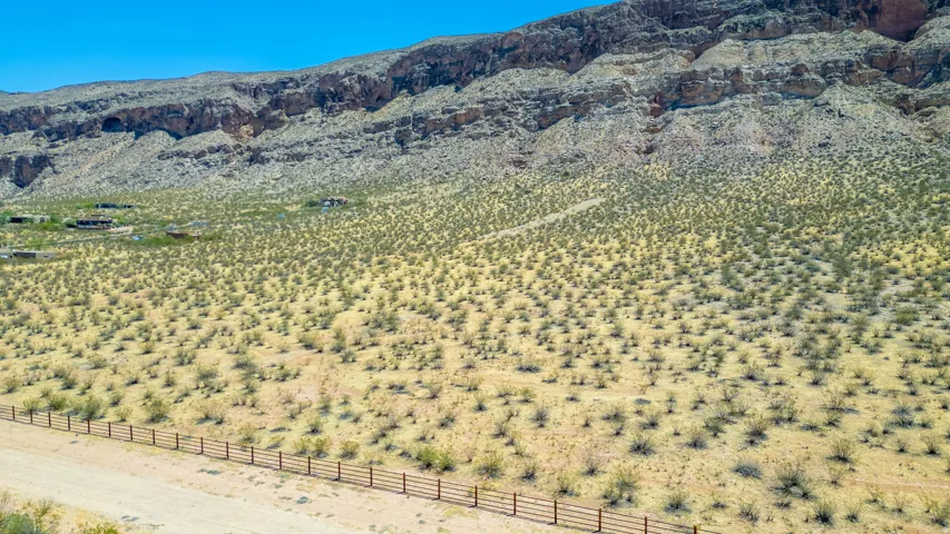 Expansive desert landscape featuring rugged mountain formations