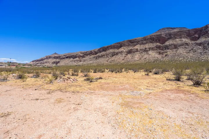 Expansive desert landscape featuring natural terrain and distant mountains