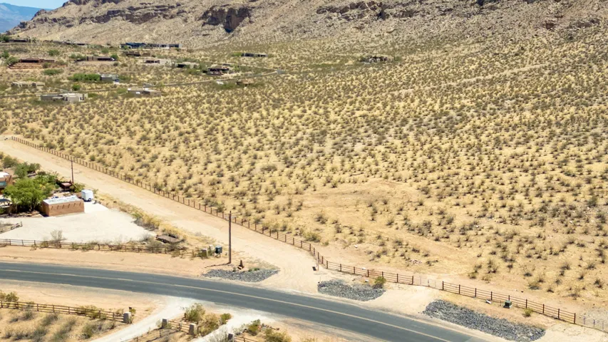 Expansive desert landscape featuring rugged terrain and distant mountain formations