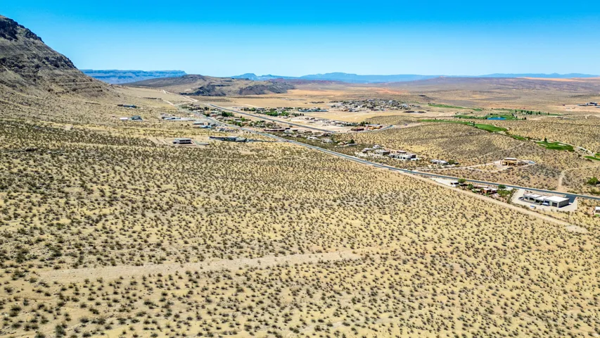 Expansive desert landscape featuring natural scrub vegetation