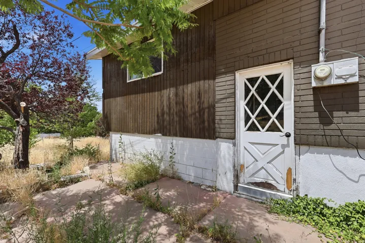Side door / entrance to the basement. Ideal of a rental income. There is a gravel parking spot on this side of the home.