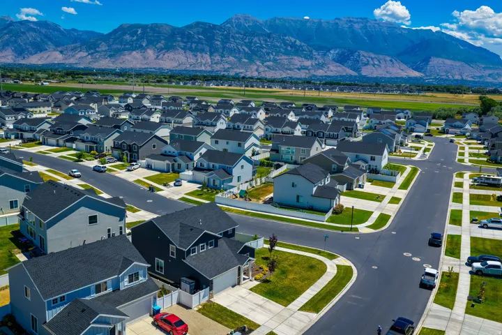 Residential neighborhood featuring a consistent architectural style with dark shingled roofs and varied siding colors