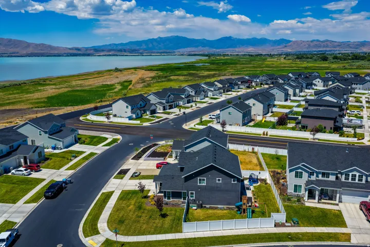 Aerial perspective showcasing a developed residential community with dark asphalt streets and light concrete sidewalks