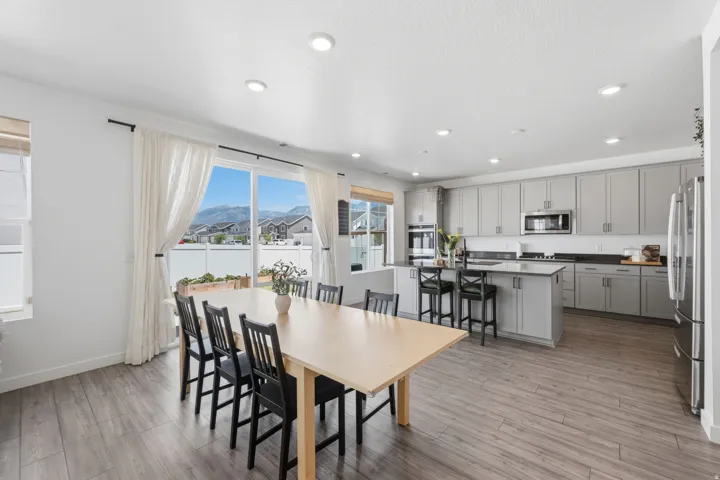 Spacious open-concept living area featuring wood-finish flooring and recessed lighting