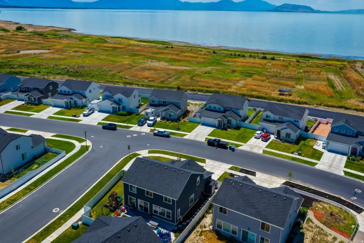 Residential development featuring single-family homes with dark asphalt shingle roofs and concrete driveways