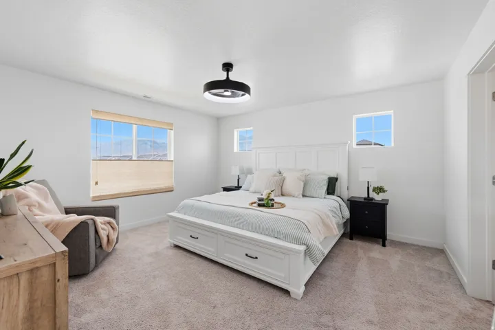 Bedroom featuring neutral carpeting and white walls