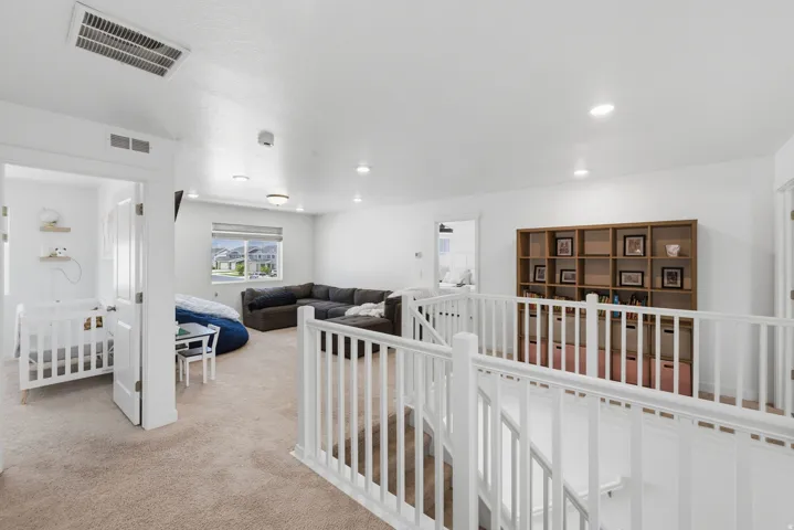 Upper level featuring carpeted flooring and white painted railings