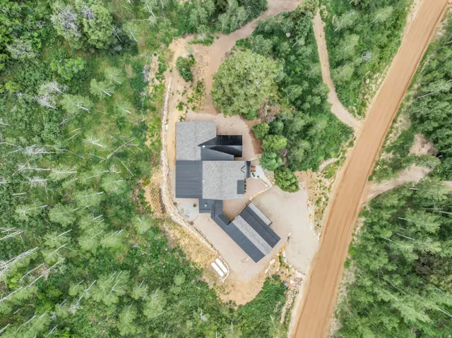 Aerial perspective showcasing a contemporary residence with a detached structure