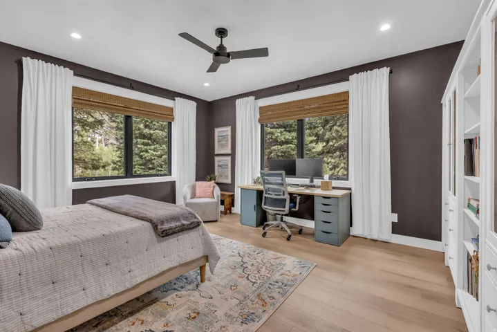 Spacious room featuring multiple windows with natural light, recessed lighting, a ceiling fan, and wood-finish flooring