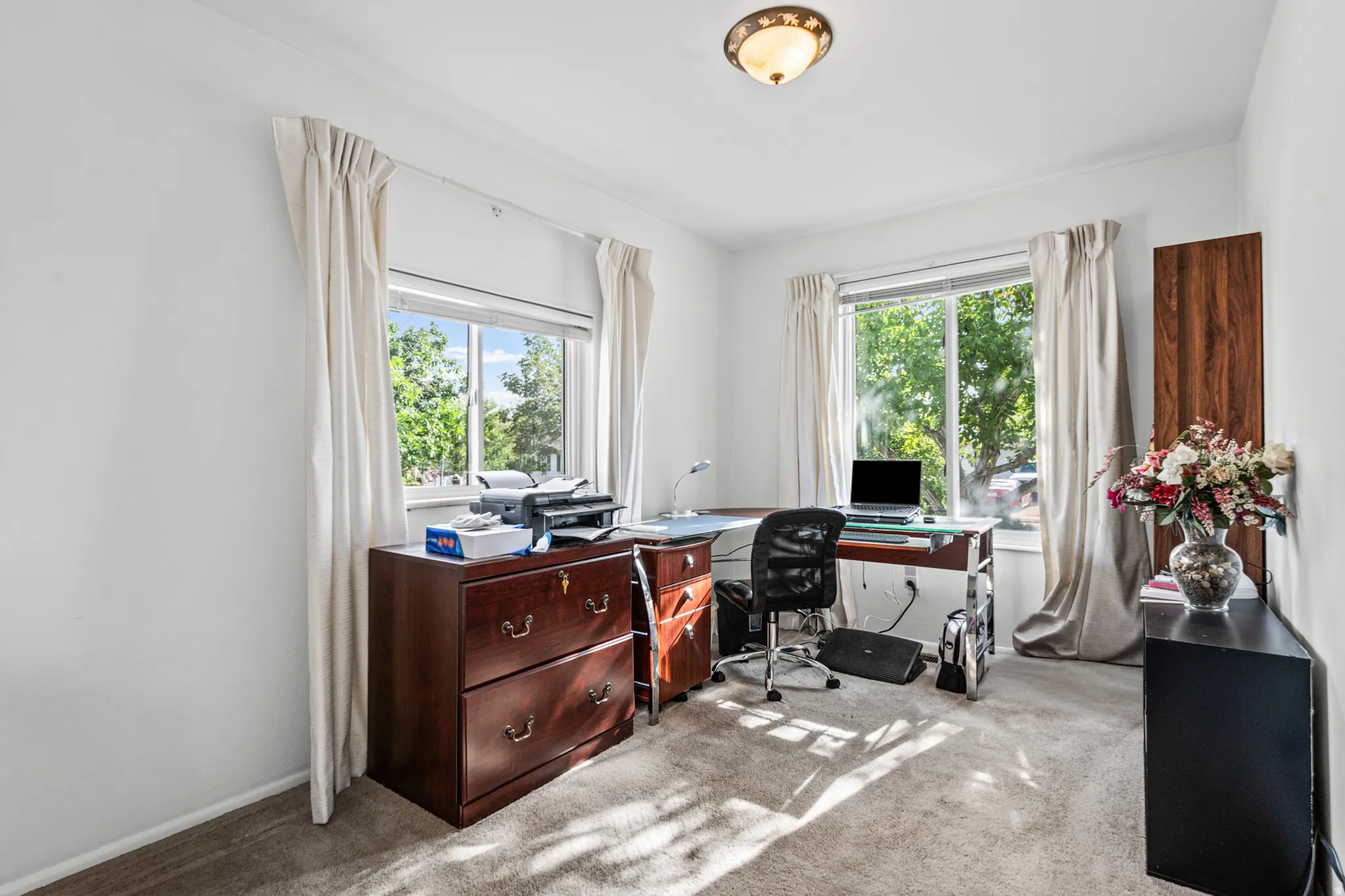 Carpeted room with white walls and crown molding