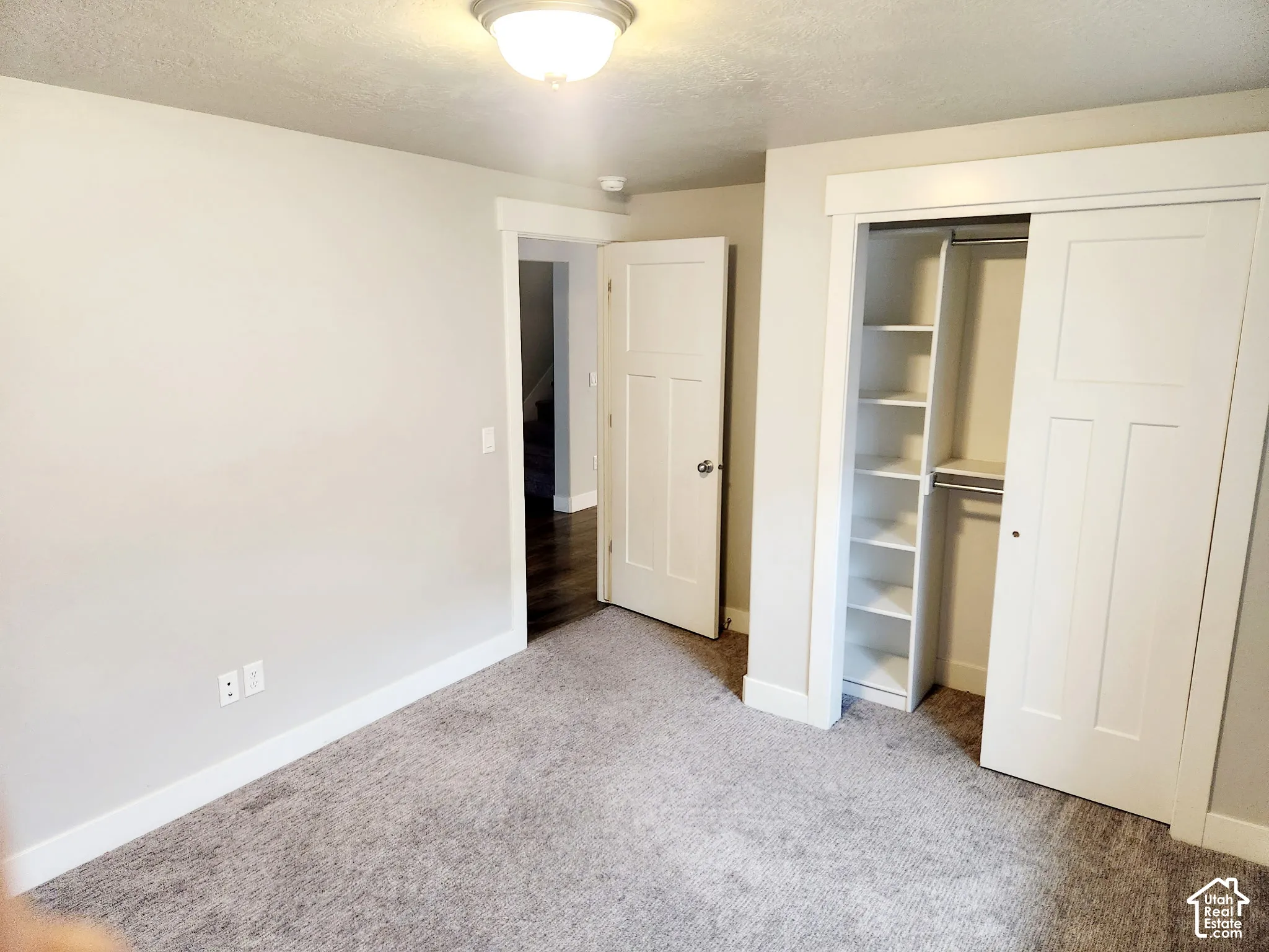 Plush gray carpeting and crisp white baseboards