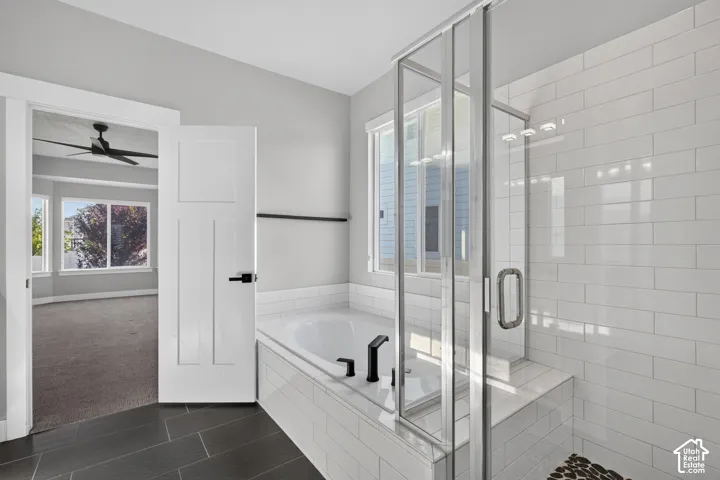 Contemporary bathroom featuring a built-in tub with matte black fixtures, a separate glass-enclosed shower with subway tile walls, and dark rectangular floor tiles