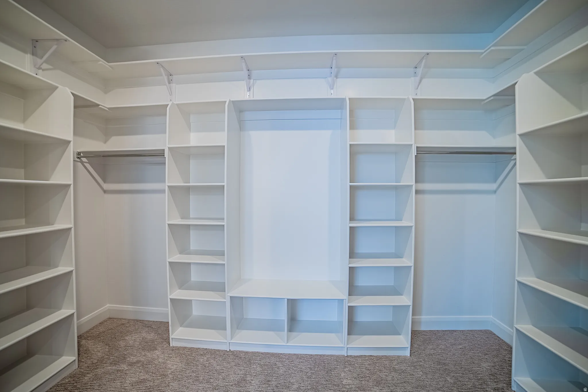 Custom closet system featuring extensive shelving, hanging rods, and built-in compartments