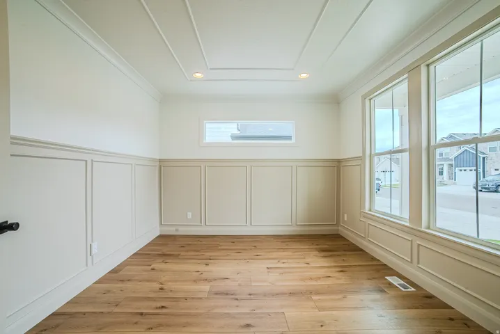 Room featuring extensive wainscoting and crown molding