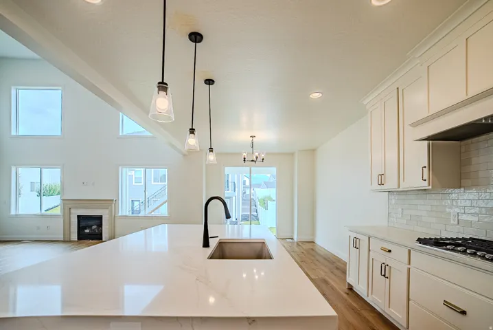 Kitchen island featuring a single-basin sink with a matte black faucet