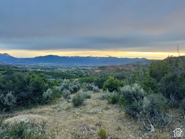Expansive rural landscape with distant mountain ranges and a visible valley