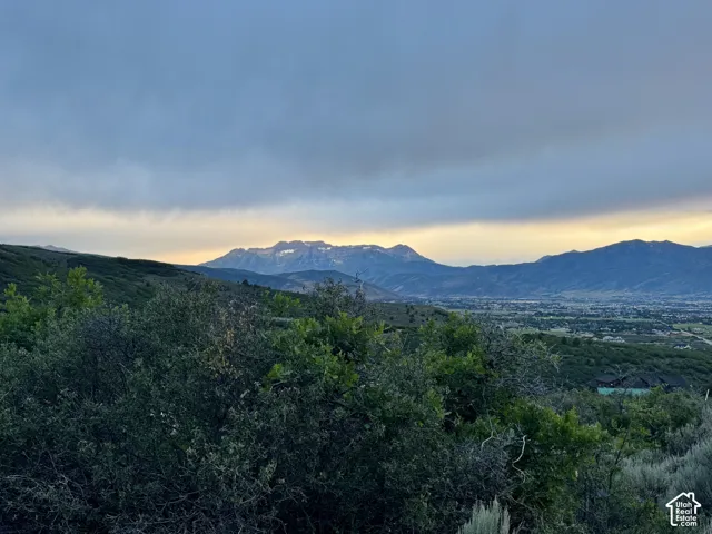 Expansive mountain scenery with distant snow-capped peaks and a valley landscape