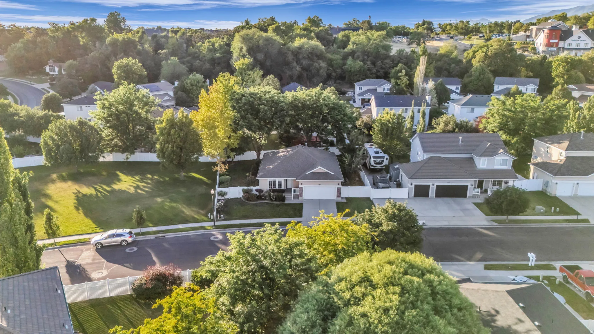 Suburban neighborhood featuring a variety of residential properties, mature trees, and paved streets
