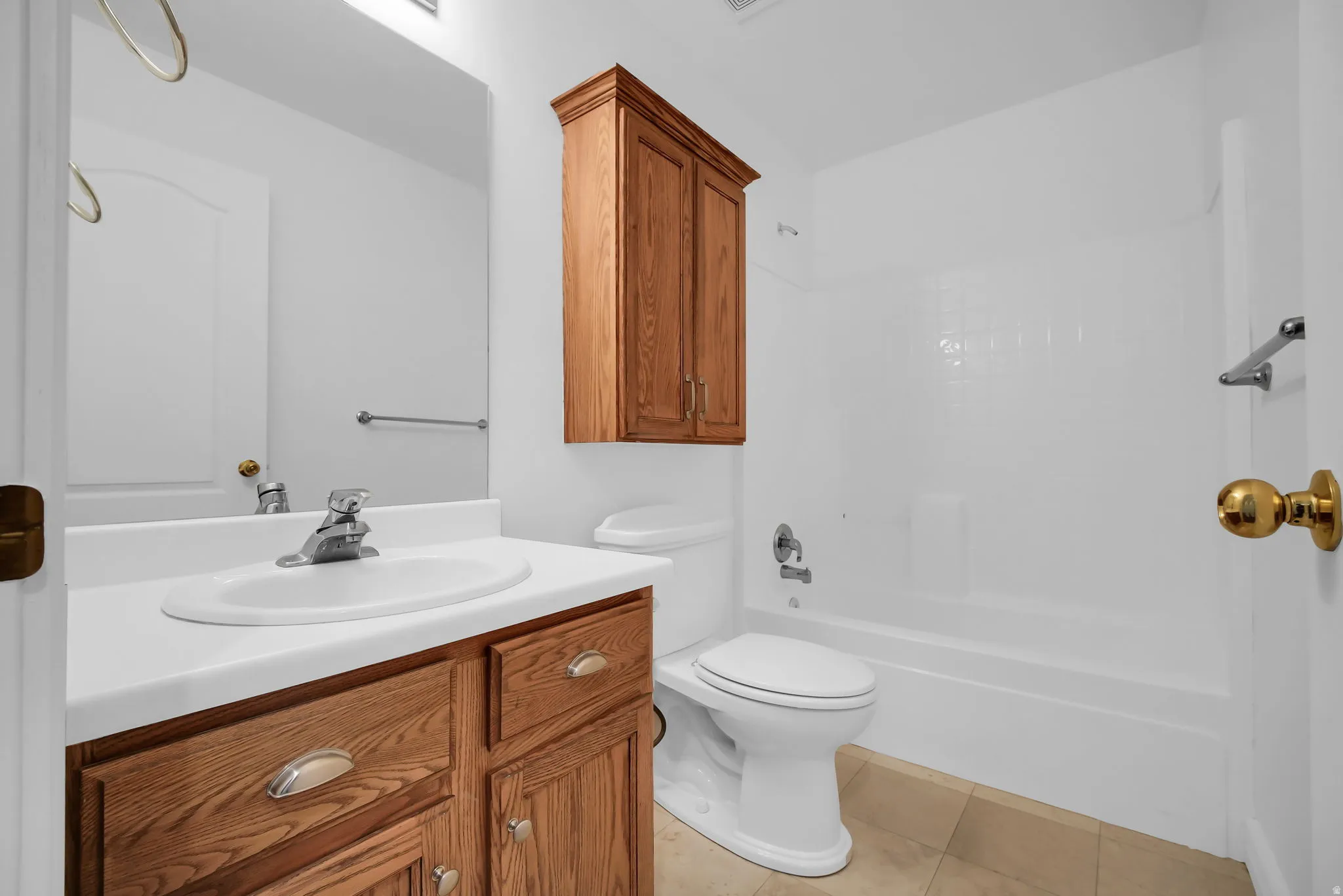 Bathroom featuring a single vanity with wood cabinetry, a white countertop, and an integrated sink