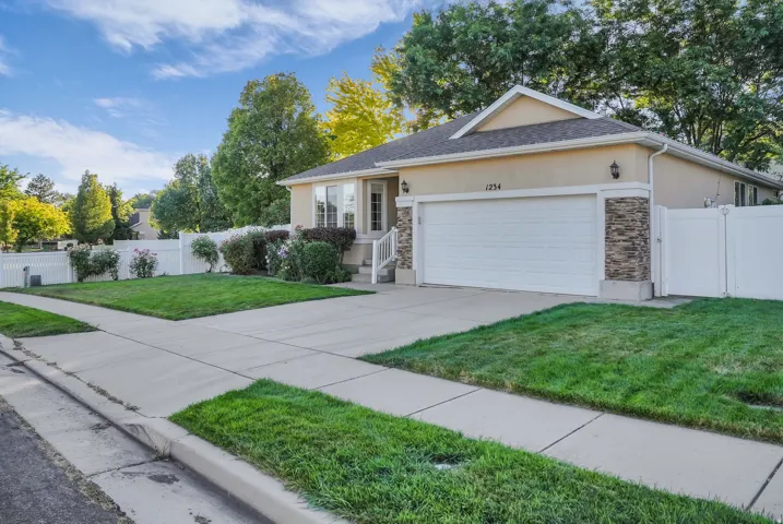 Stucco exterior with stone accents and a two-car garage
