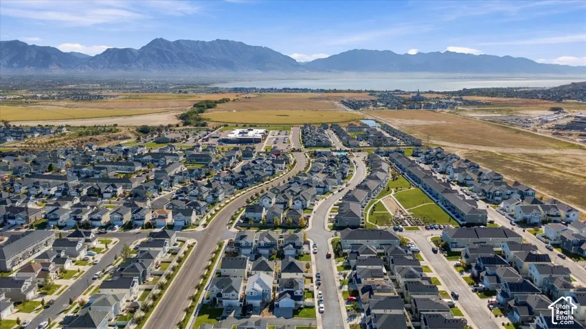 Expansive residential development with a mountain backdrop and a distant body of water