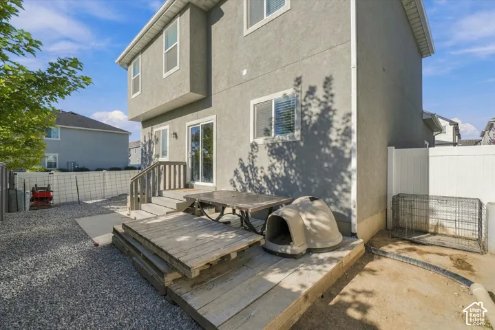 Exterior stucco finish, dual-pane windows, and a sliding glass door