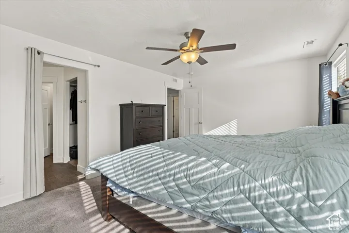 Primary bedroom with natural light and ceiling fan.  Lovely views.