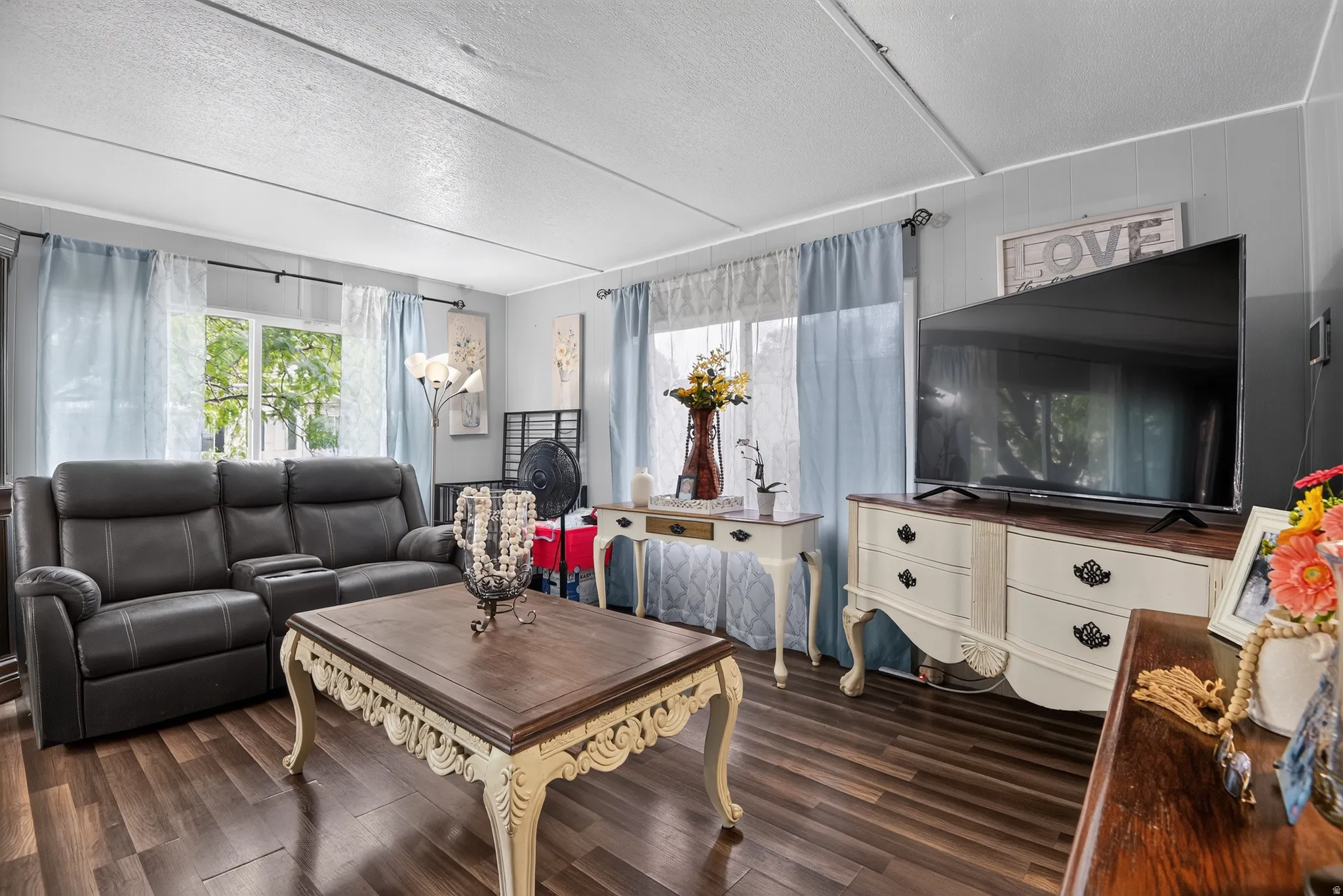 Living area featuring wood-finish flooring and two large windows