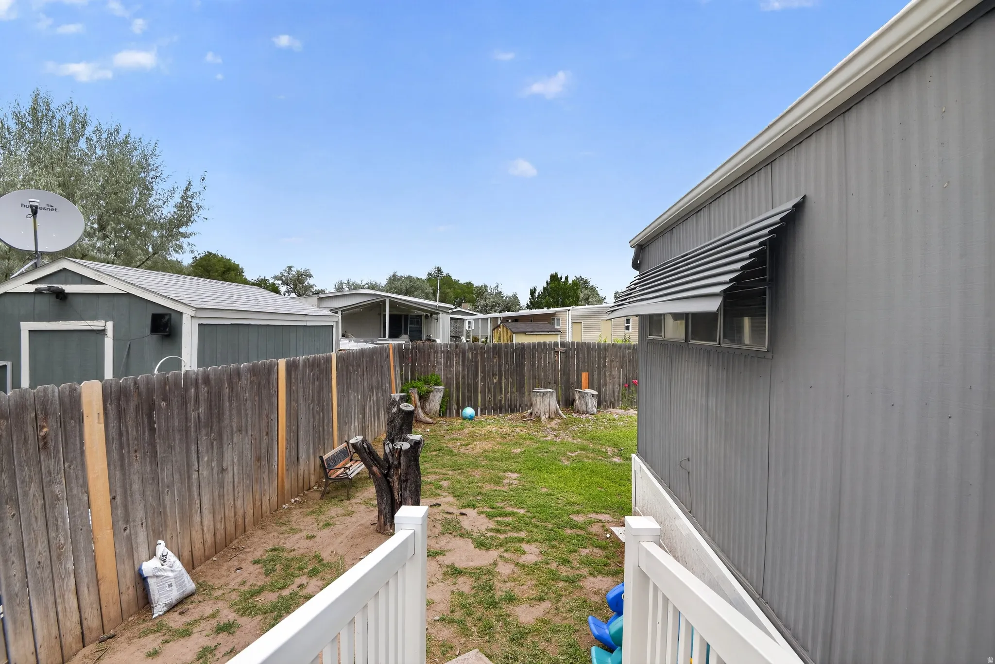 Fenced backyard featuring a gravel and grass ground covering