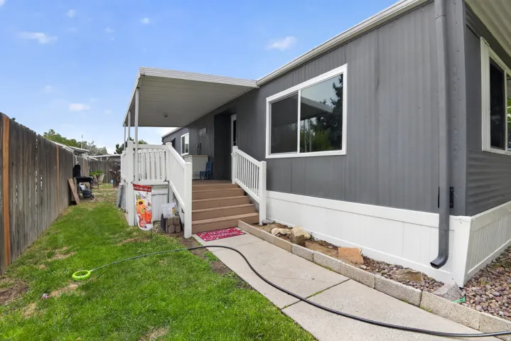 Grey exterior siding with white trim and white skirting