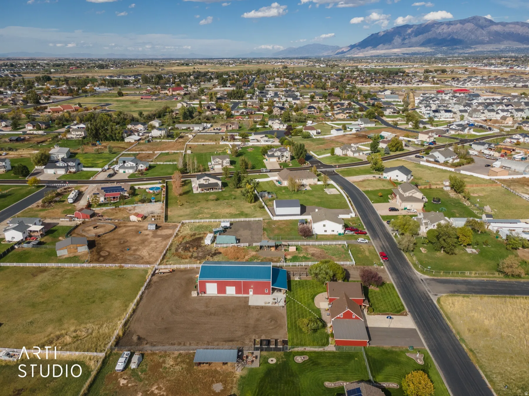 Aerial view showcasing expansive residential properties with a mountainous backdrop