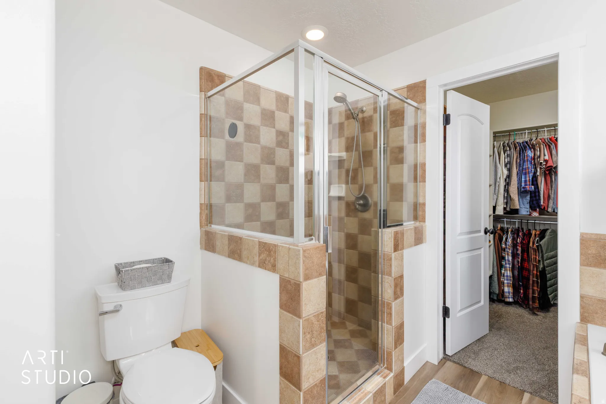 Walk-in shower with clear glass enclosure and checkerboard tile