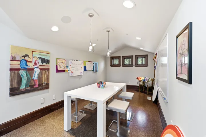 Vaulted ceiling with recessed lighting and pendant fixtures