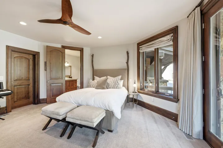 Carpeted room with recessed lighting and a wood-finish ceiling fan