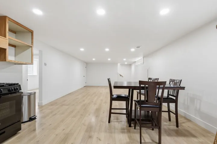 Expansive open-concept living area featuring light wood-finish flooring and recessed lighting