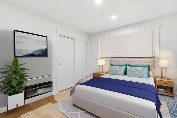 Bedroom featuring recessed lighting, light wood-finish flooring, and a large window with blinds
