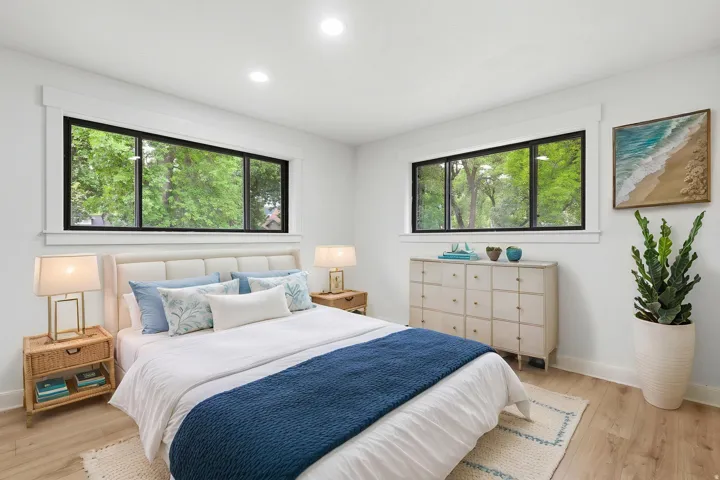 Bright room featuring wood-finish flooring and recessed lighting