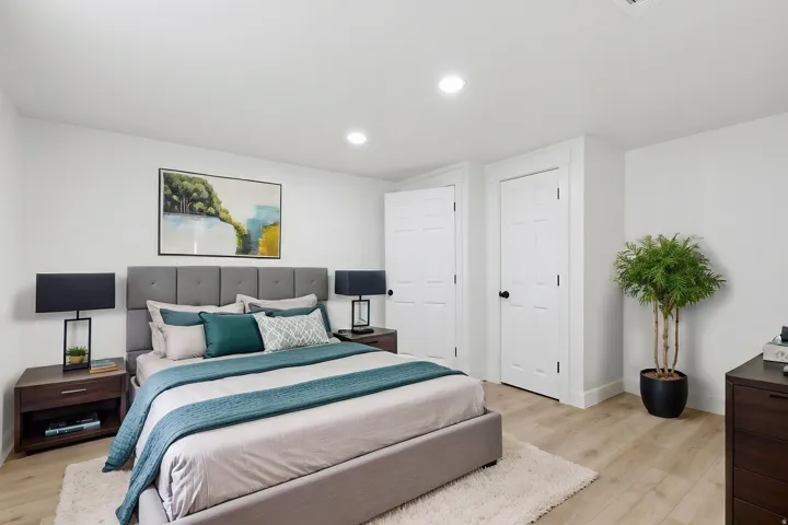 Neutral-toned interior featuring wood-finish flooring, recessed lighting, and white walls