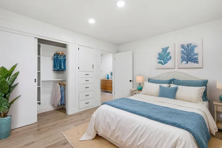 Recessed lighting illuminates this bright room featuring light wood-finish flooring