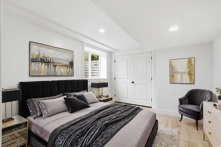 Light wood-finish flooring, recessed lighting, and a window with blinds provide illumination