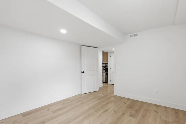 Light wood-finish flooring complements crisp white walls and baseboards
